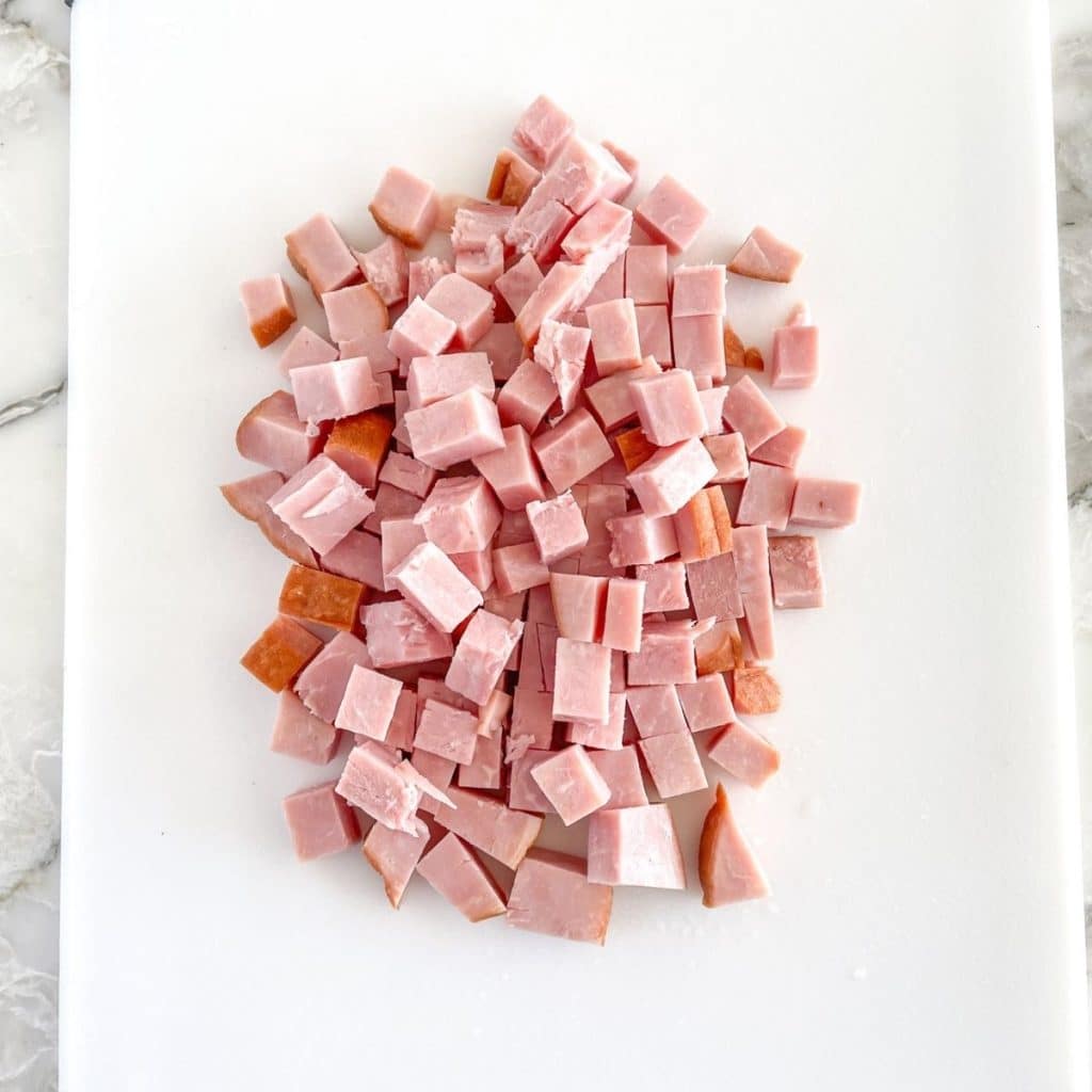 Diced ham on a cutting board.