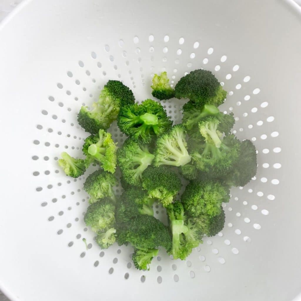 Colander with broccoli.