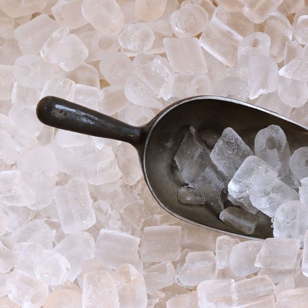 Bunch of ice cubes with a scoop.