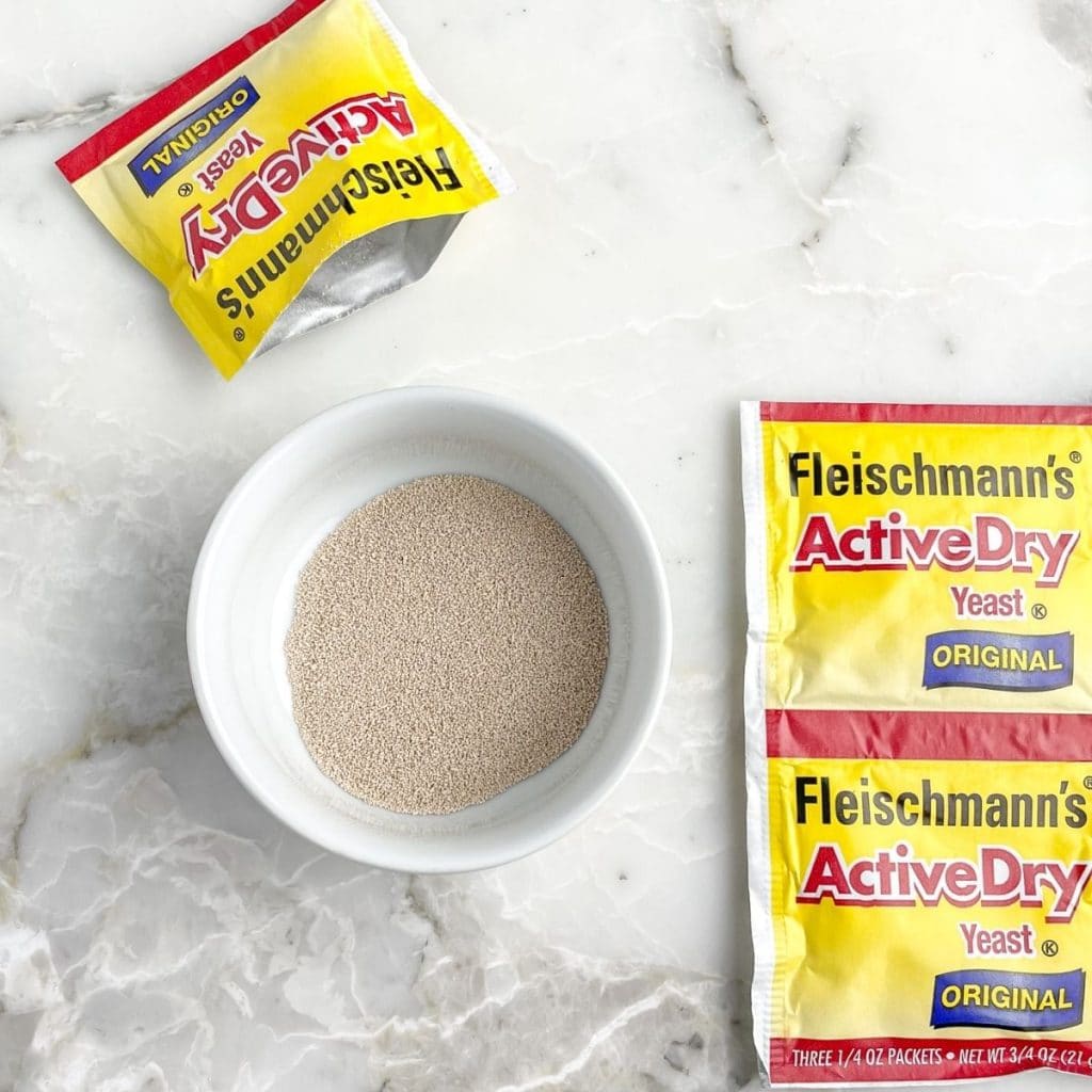 Bowl of yeast and instant yeast packets.