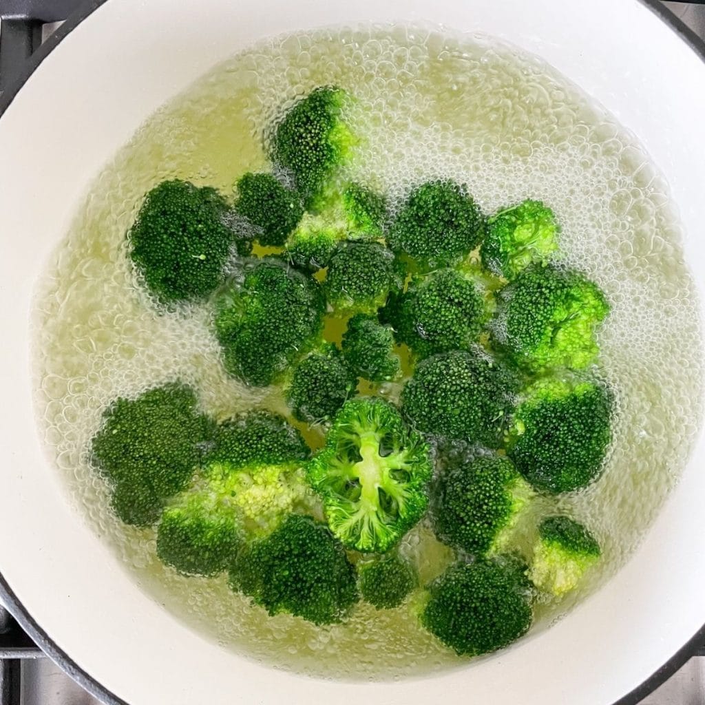 Broccoli florets in boiling water. 
