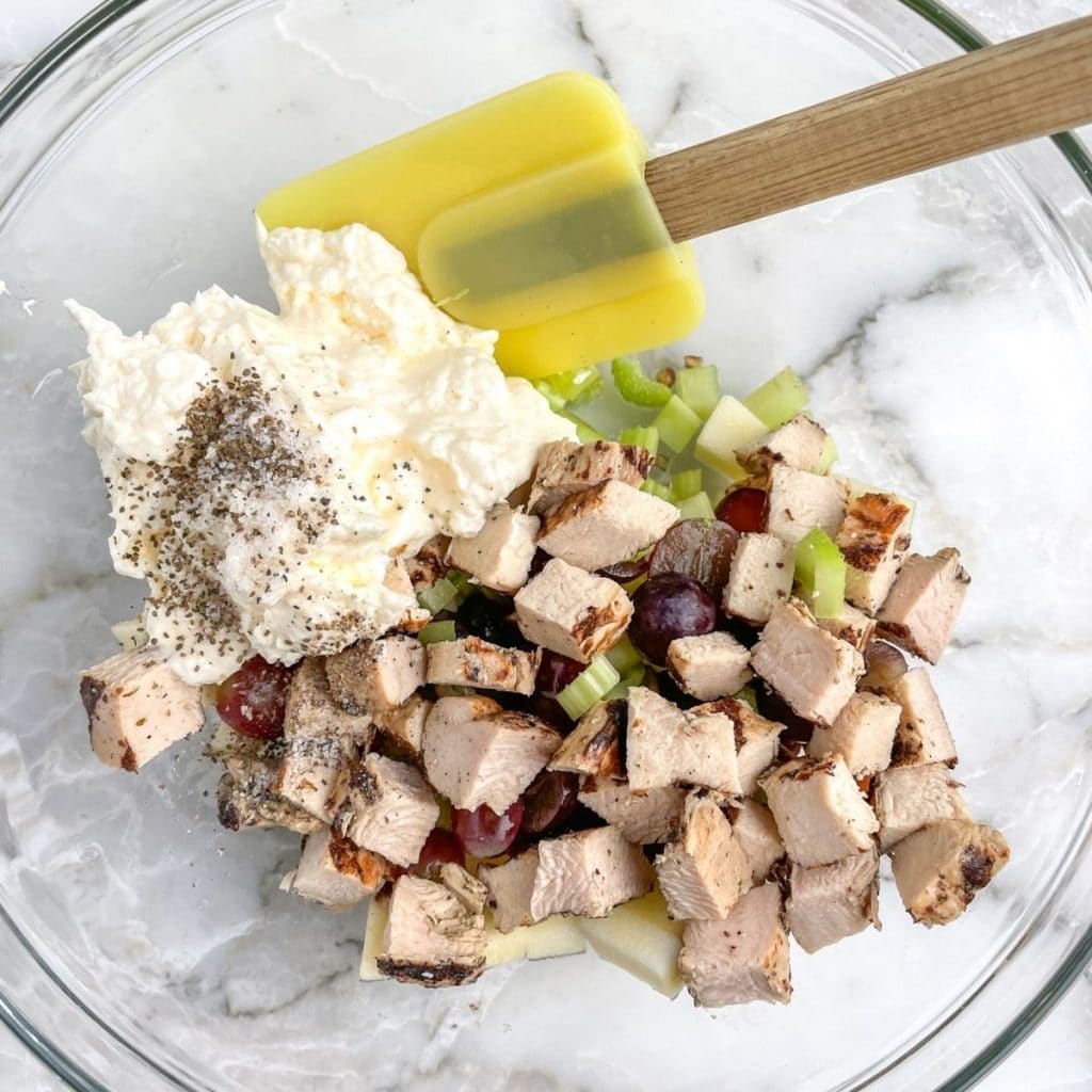 Bowl of mayo, diced chicken, celery, and seasonings. 