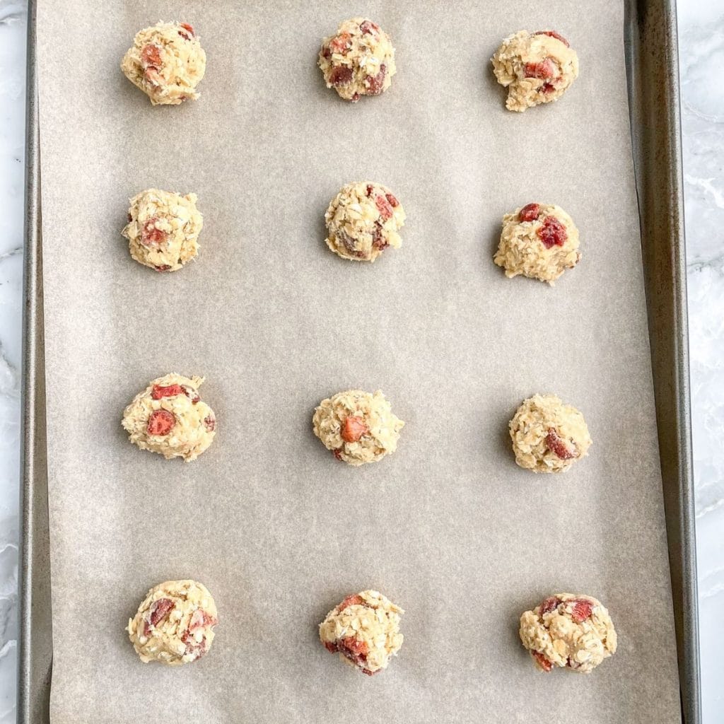 Cookie dough balls on baking sheet.