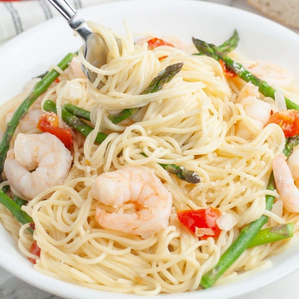 Fork in pasta and shrimp.