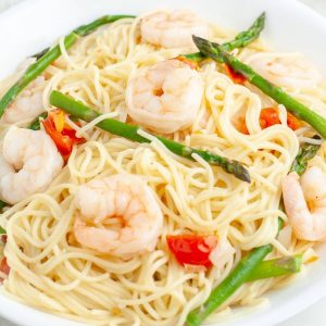Bowl of pasta, shrimp, and asparagus.