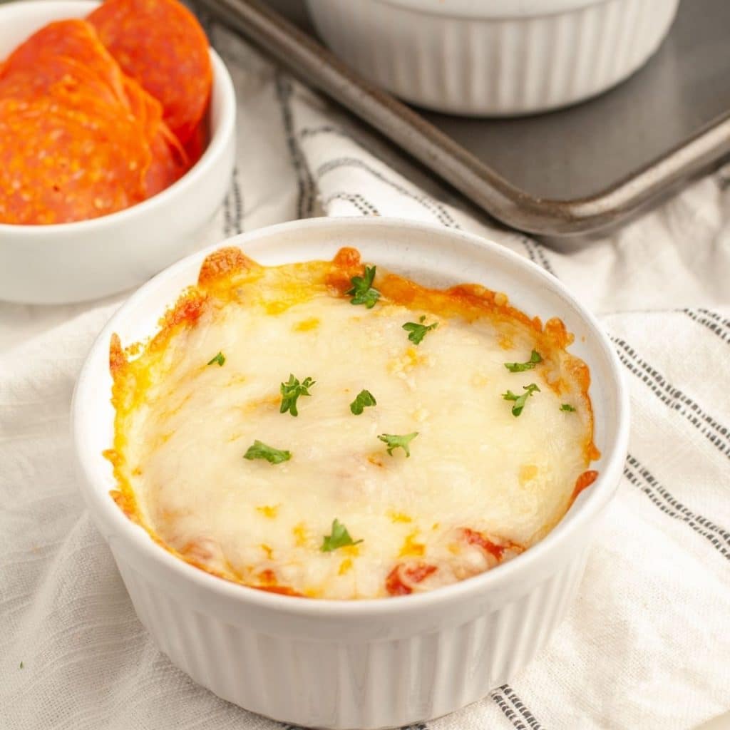Small bowl with melted cheese.