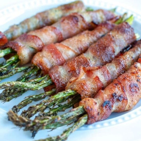 Bacon wrapped asparagus on plate.