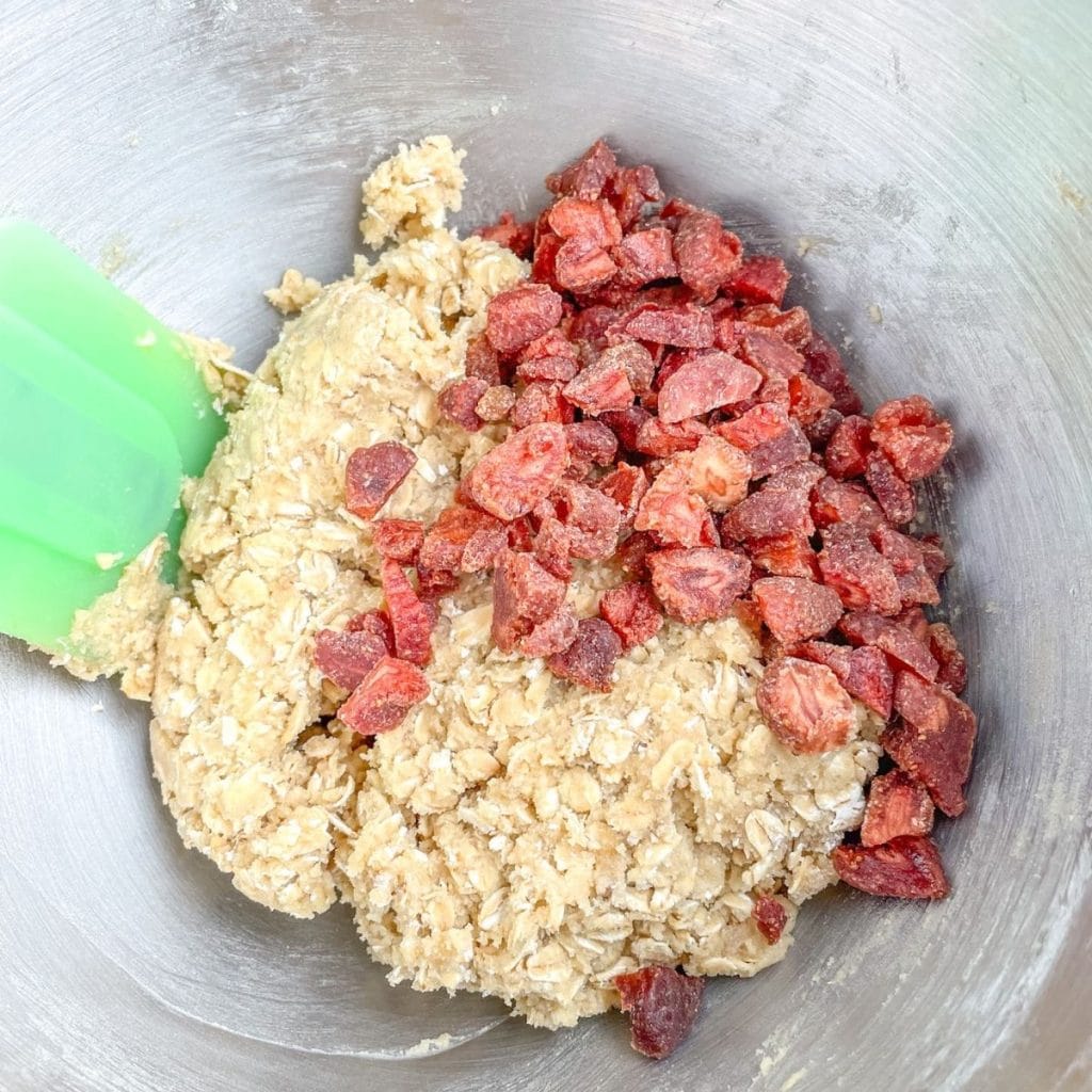 Mixing bowl with batter and dried strawberries. 