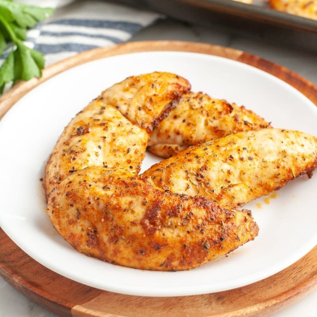 Plate of cooked chicken tenders. 