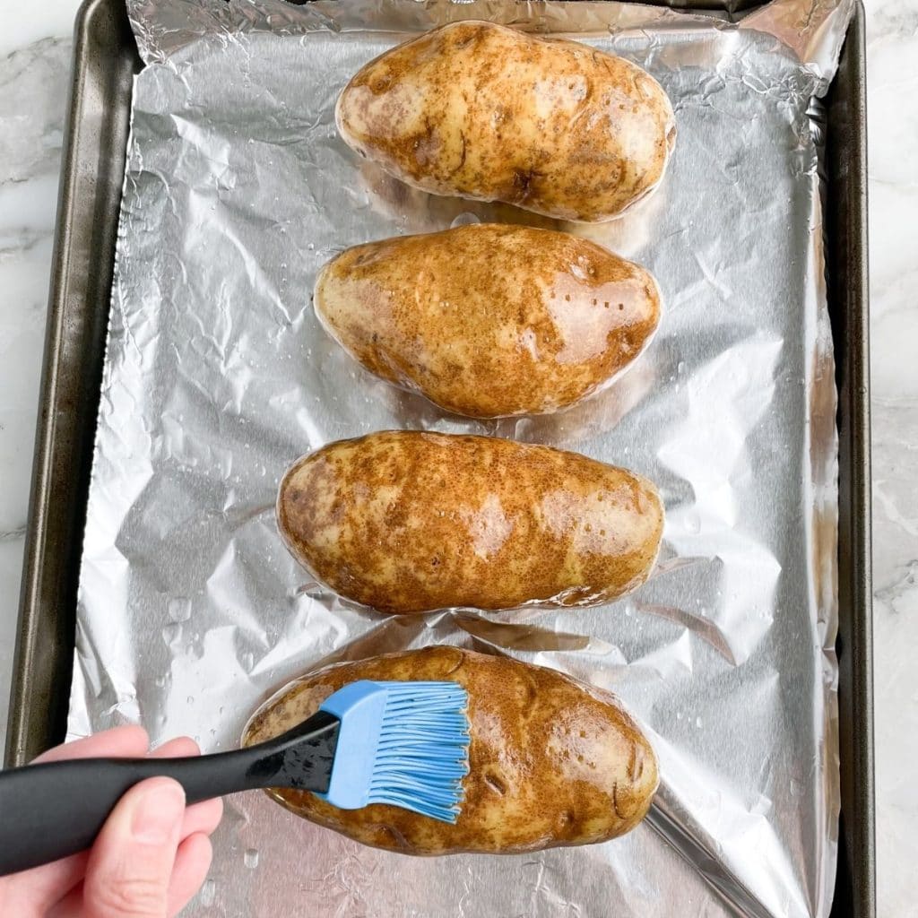 Oil brushing on potatoes. 