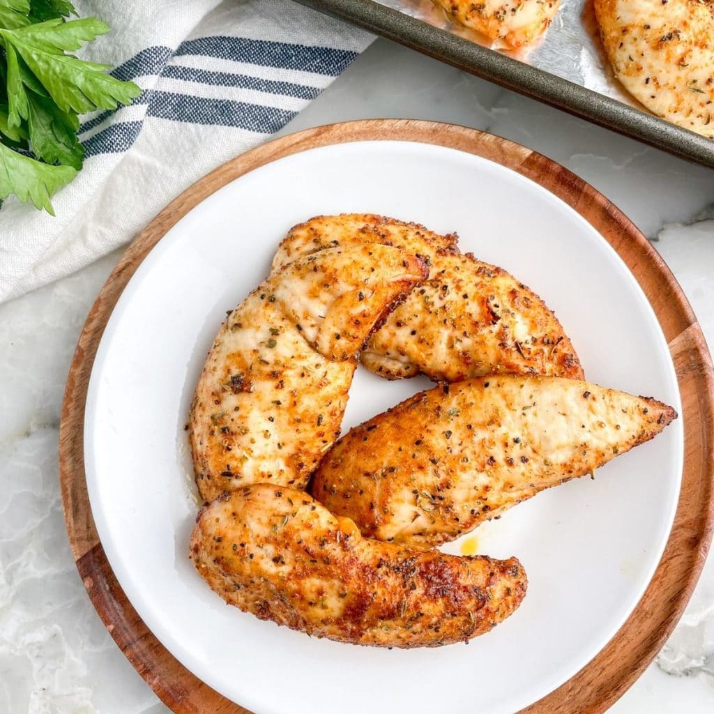 Chicken tenders on a plate.