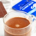 Cup of coffee with a bar of chocolate.