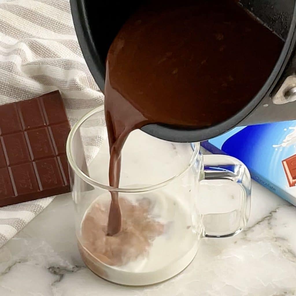 Pot of coffee pouring into mug.