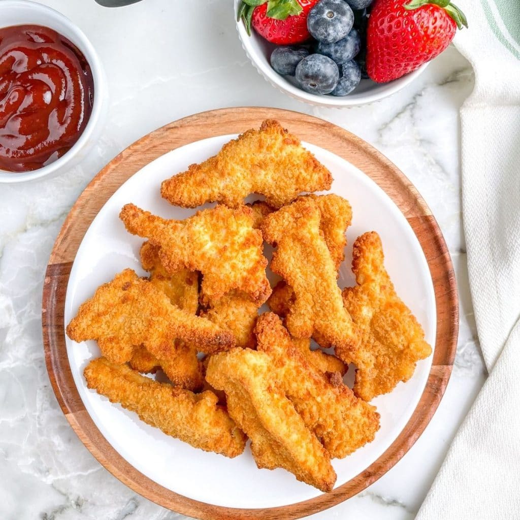 Plate of dinosaur shaped chicken nuggets. 