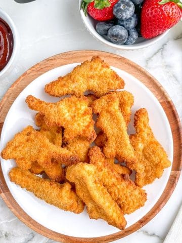 Plate of dinosaur shaped chicken nuggets.