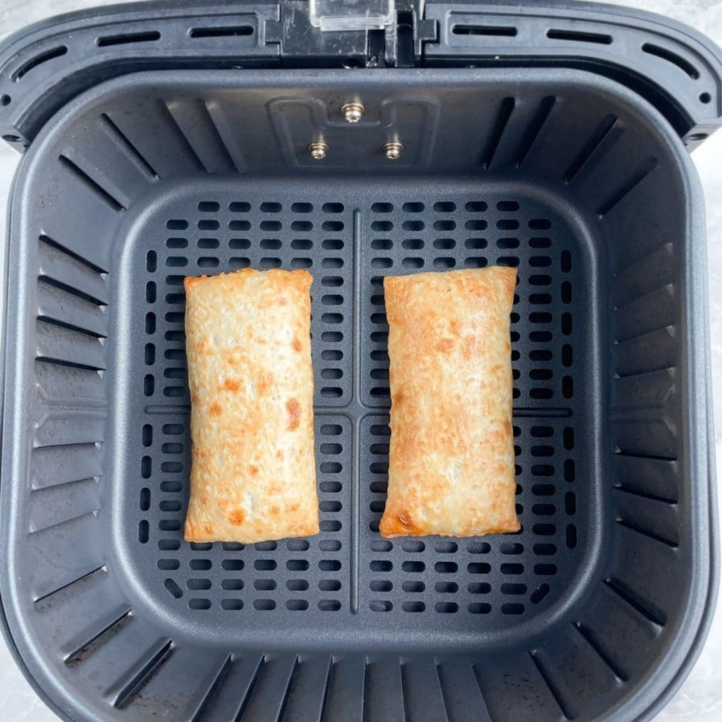 Cooked Hot Pockets in air fryer basket.