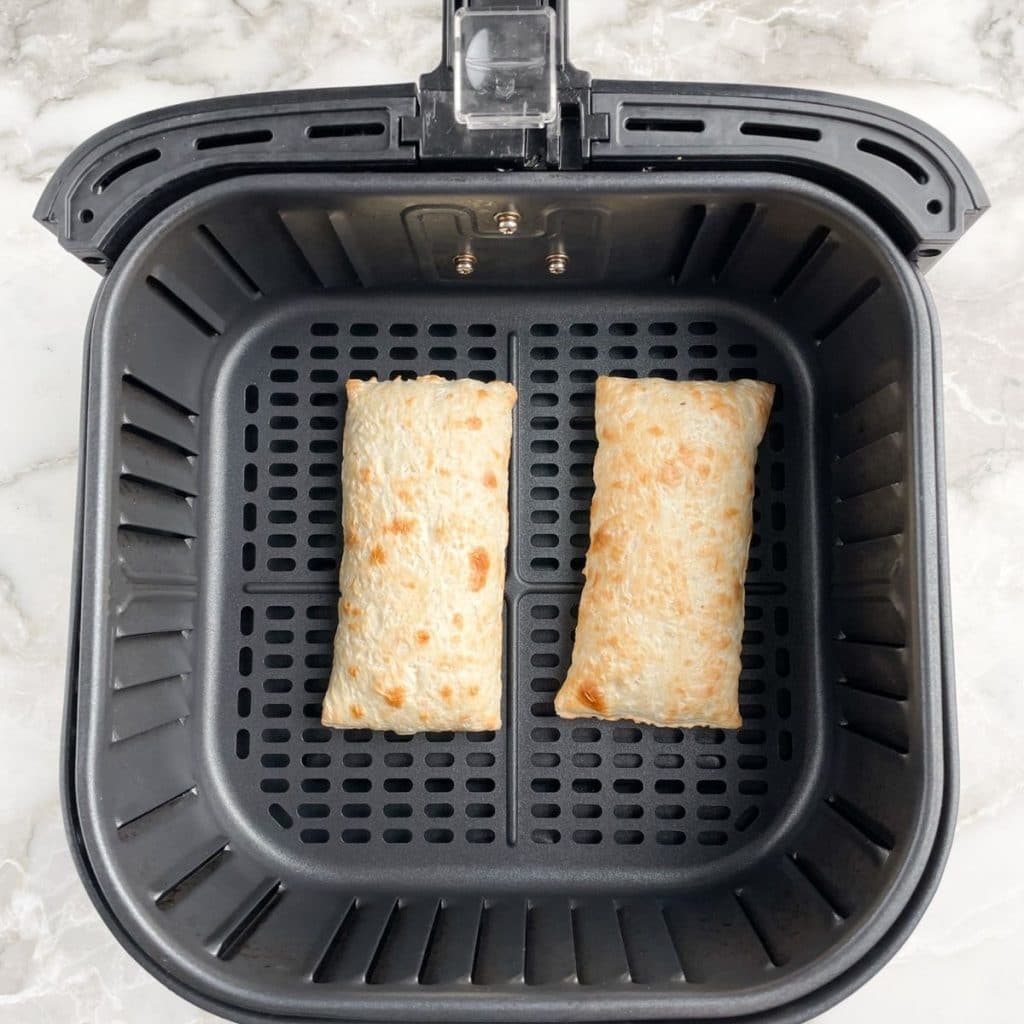 Frozen hot pockets in air fryer basket.