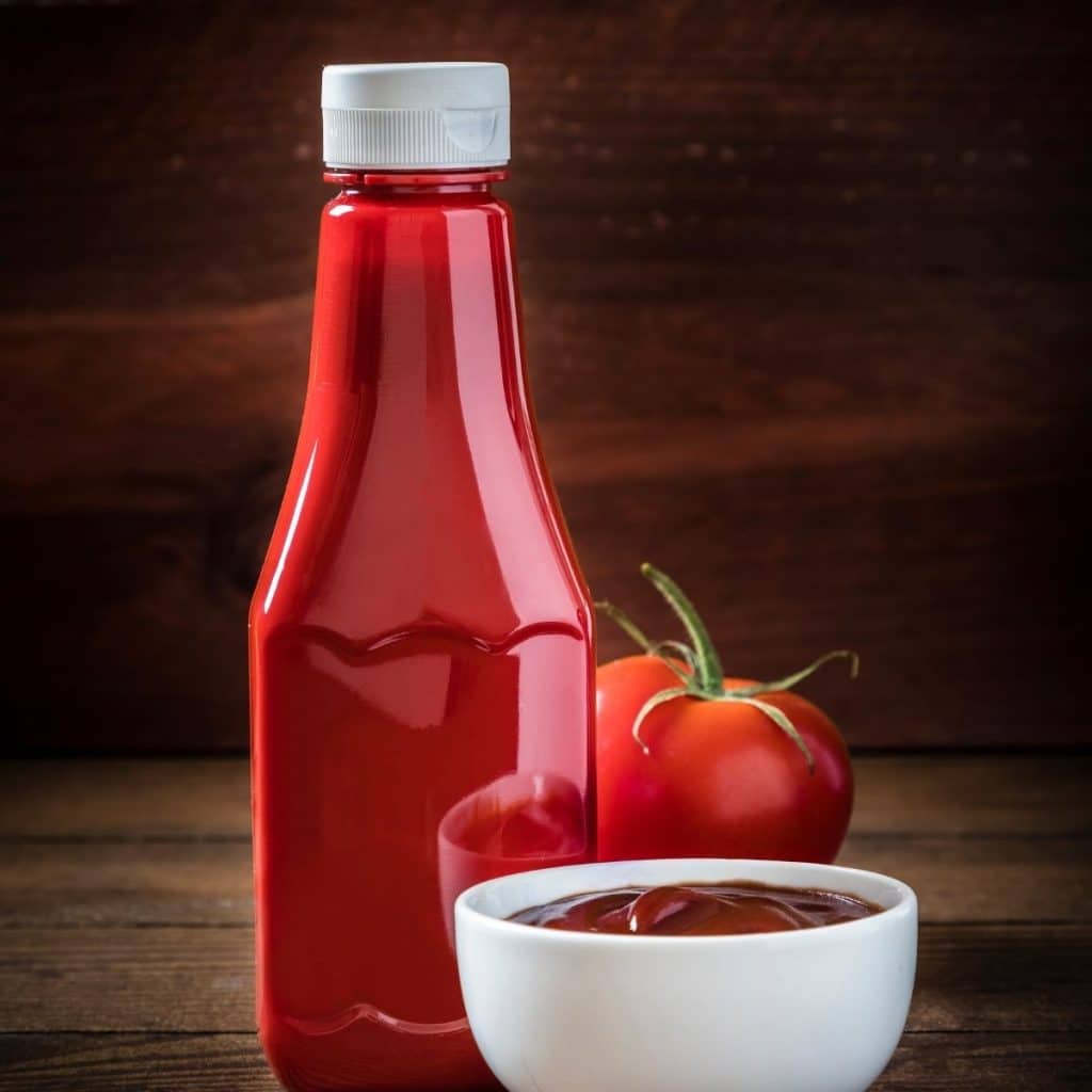 Bottle and bowl of ketchup.