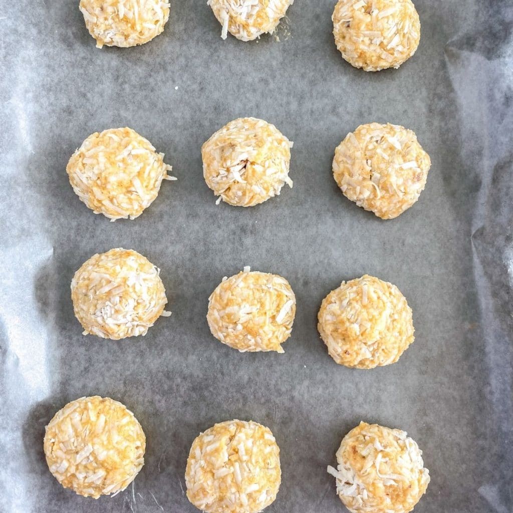 Coconut balls on a baking sheet. 