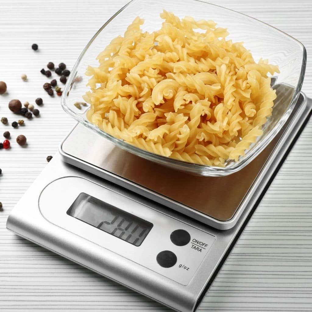 Kitchen scale with dry pasta. 