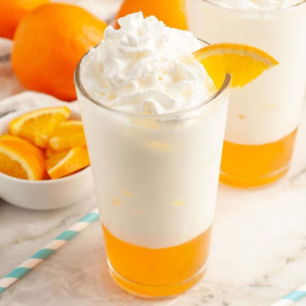 Glass of orange cream soda with orange slice. 