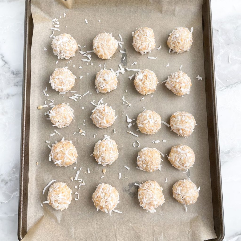 Coconut balls on a baking sheet.