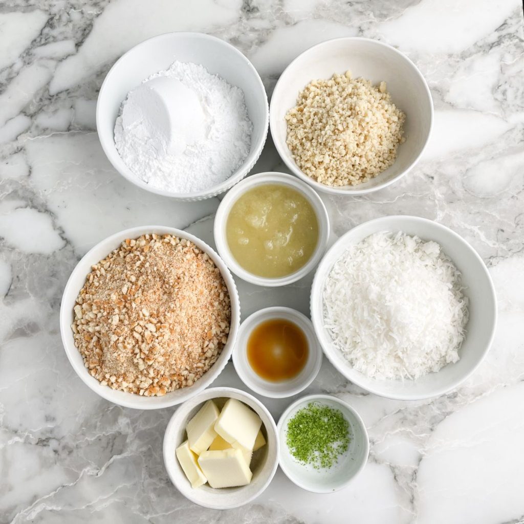 Bowl of powdered sugar, cookie crumbs, butter, nuts, and coconut flakes. 