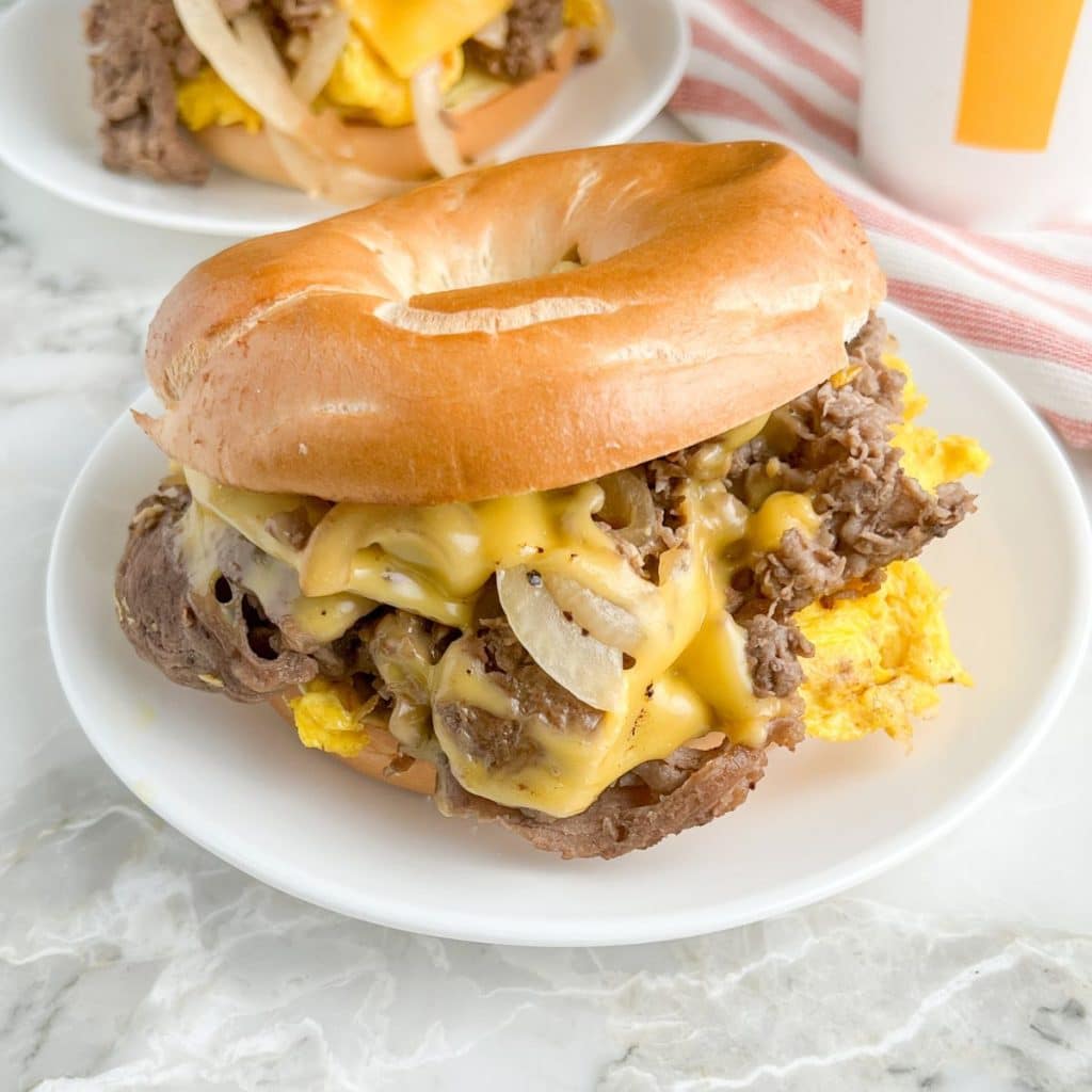 Steak bagel on a plate. 