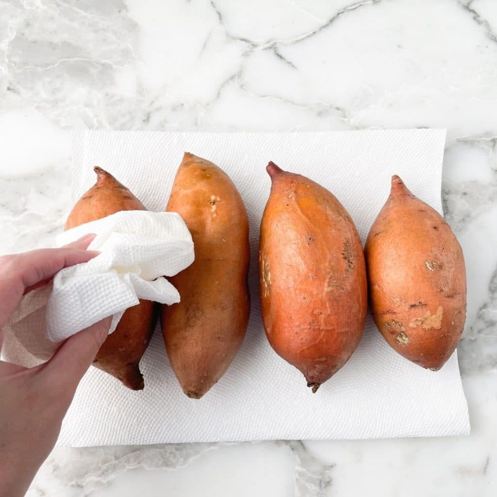 Paper towel drying off sweet potatoes. 
