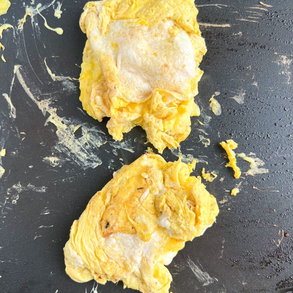 Scrambled eggs on skillet.