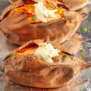 Baked sweet potatoes topped with butter.