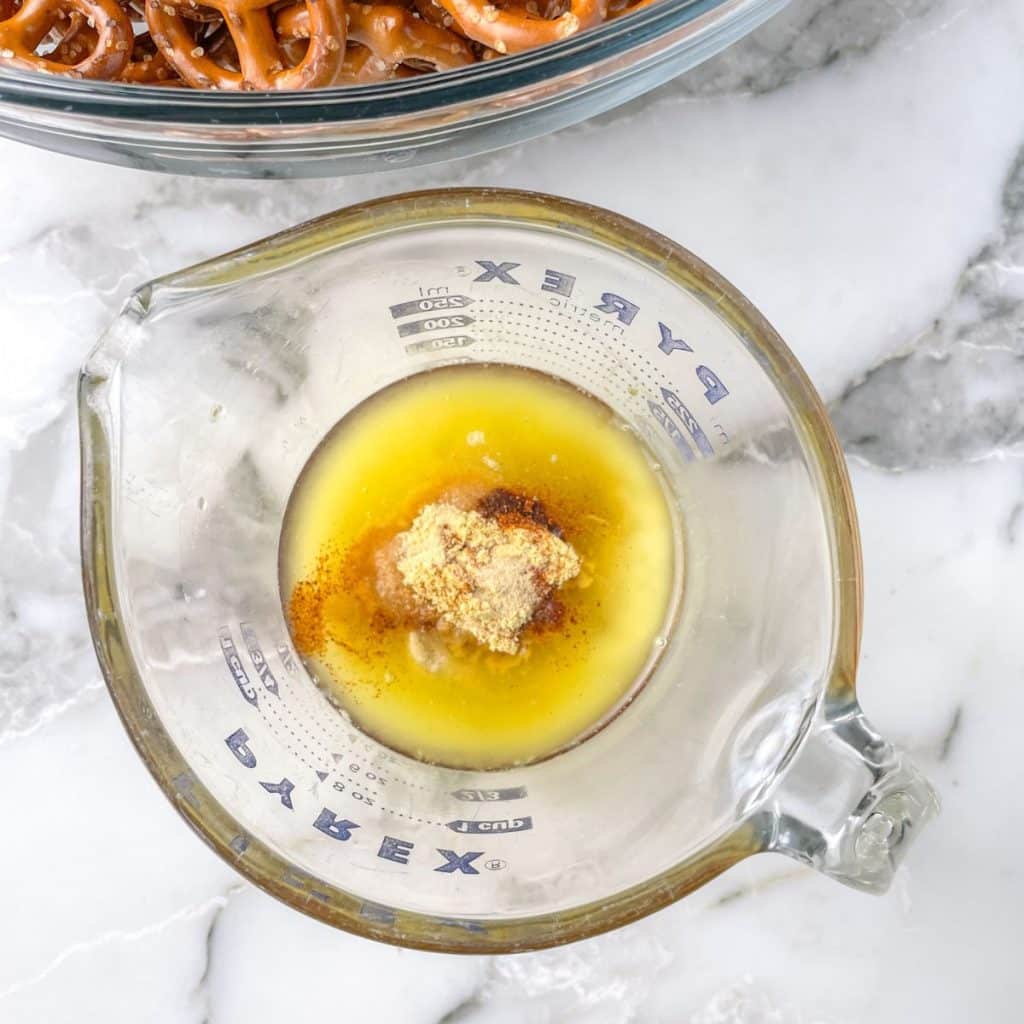 Measuring cup with melted butter and spices. 