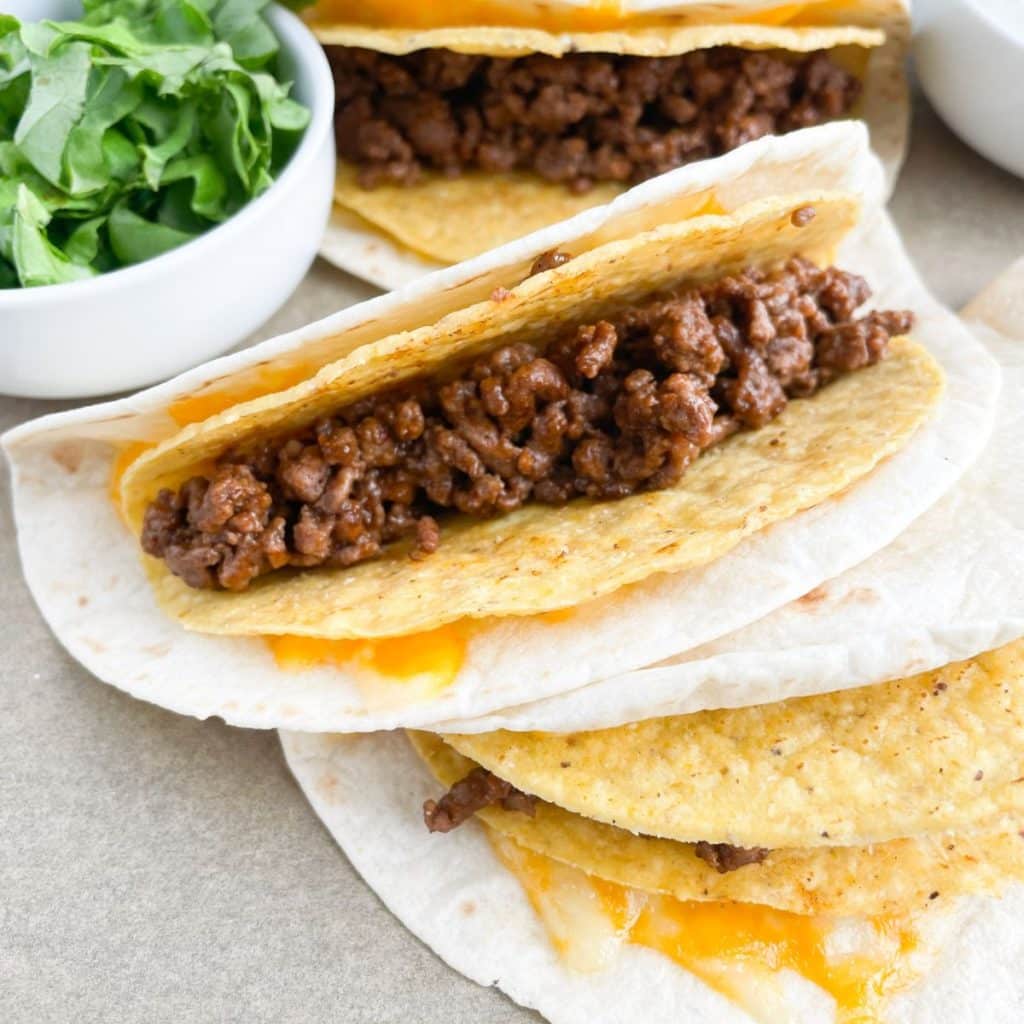 Flour tortilla and taco shell filled with ground beef. 