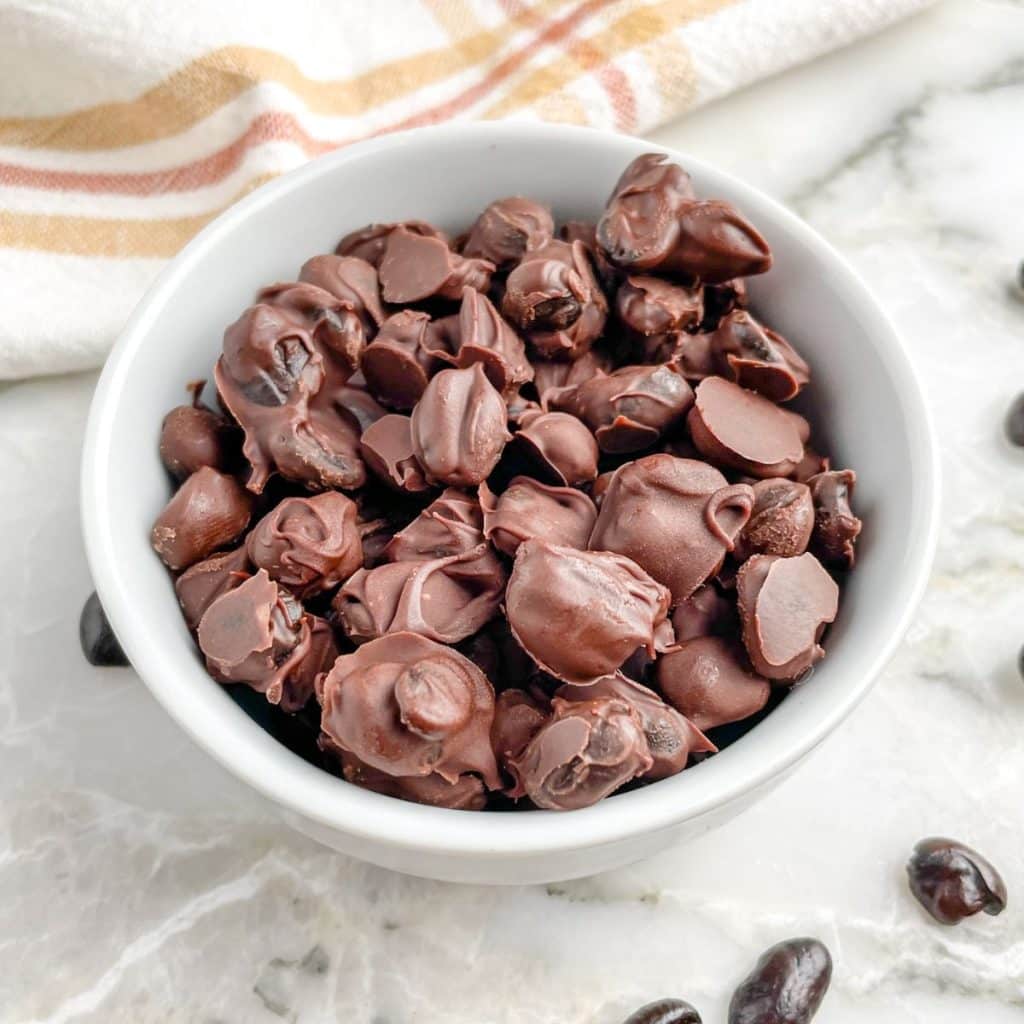 Bowl of chocolate covered coffee beans.