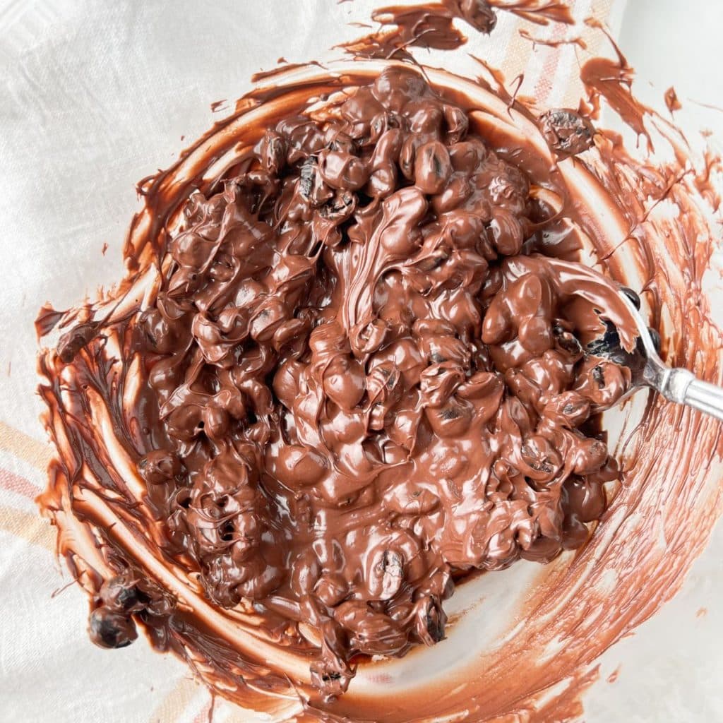 Bowl of melted chocolate with espresso beans.