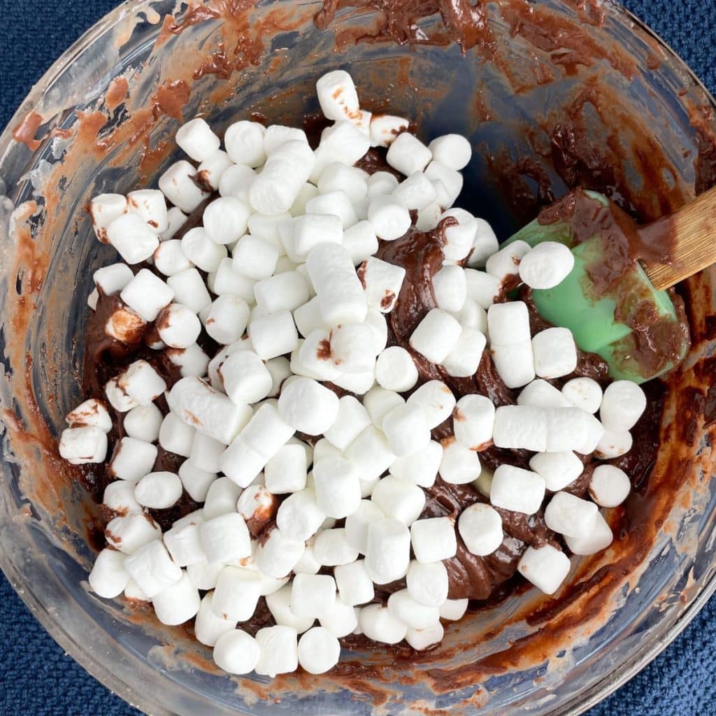 Bowl with melted chocolate and mini marshmallows.