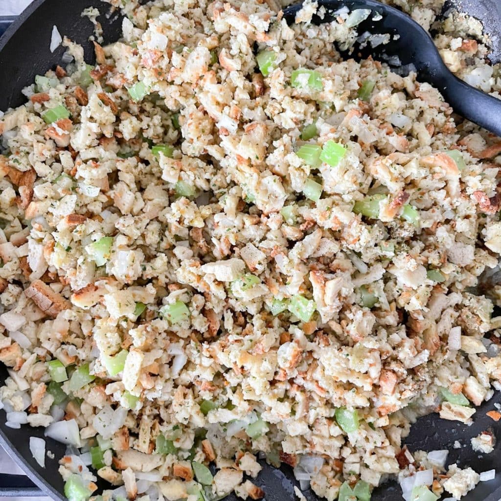 Skillet with bread crumbs and diced celery. 