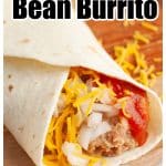 Bean burrito on wooden plate.