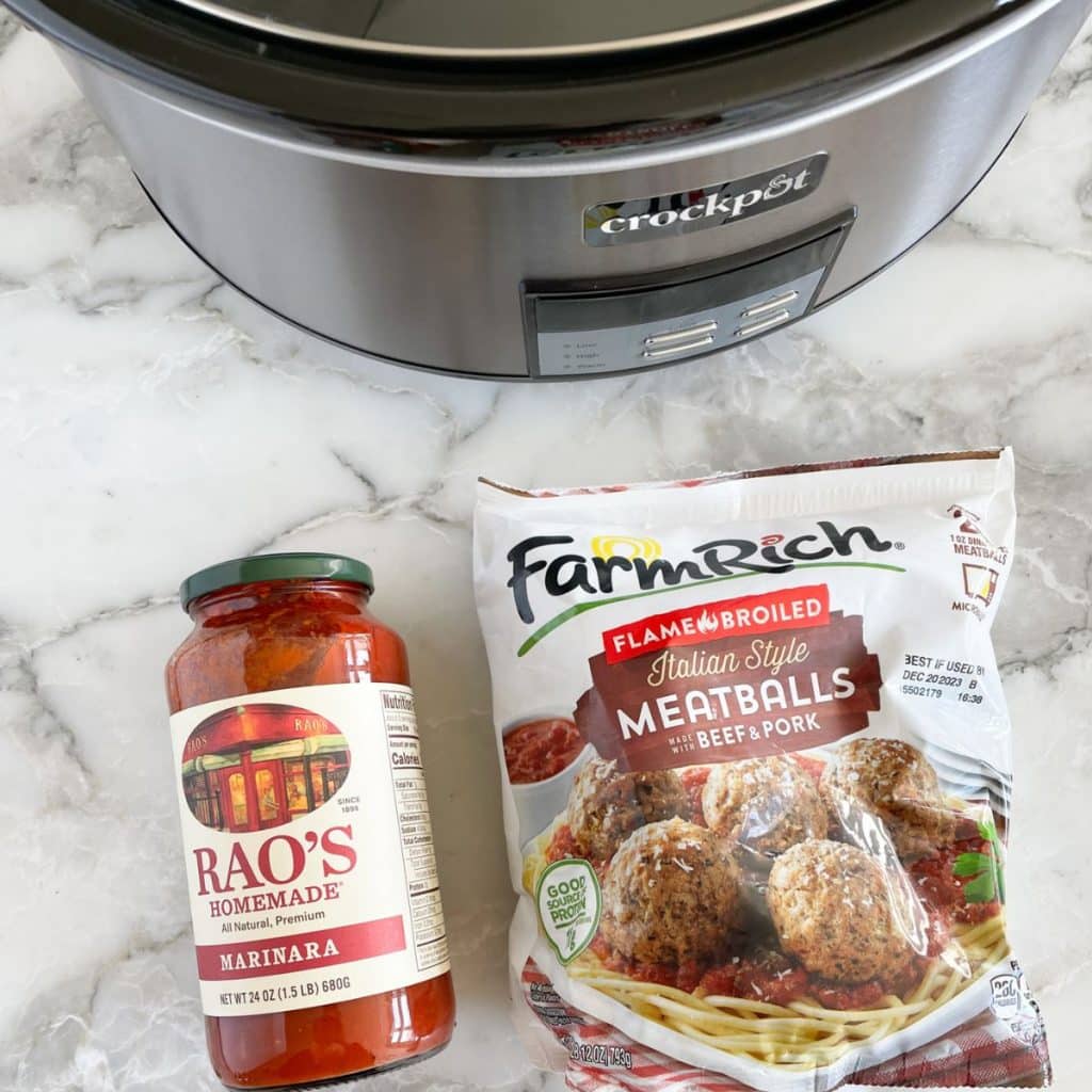 Crockpot, jar of tomato sauce, and bag of frozen meatballs.