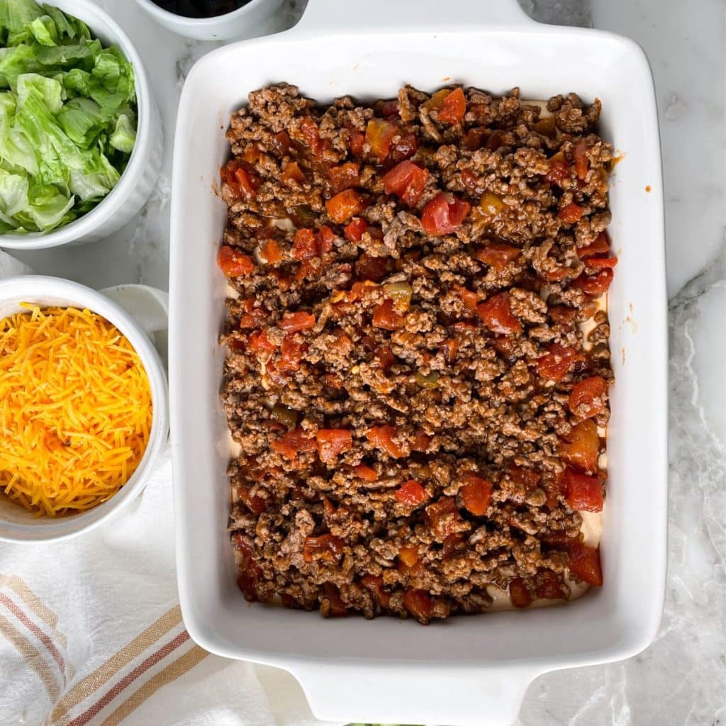 Casserole dish filled with ground beef and tomatoes.