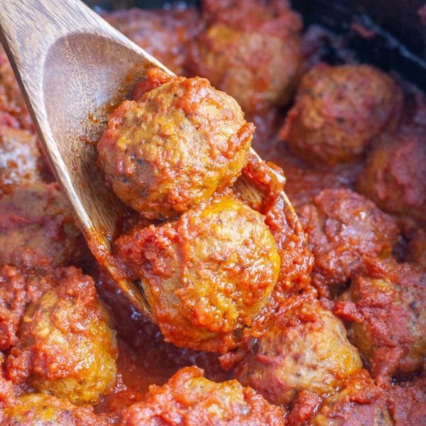 Wooden spoon with meatballs.