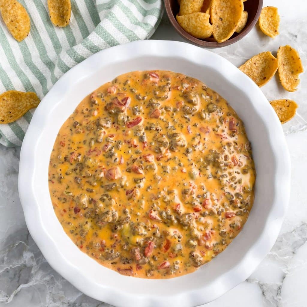 Plate of cheese dip and corn chips. 