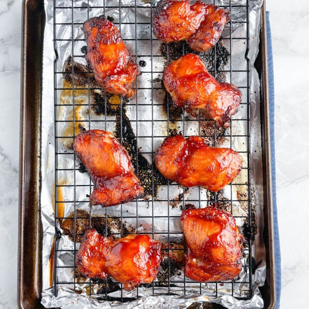 Baking sheet with bbq chicken thighs.