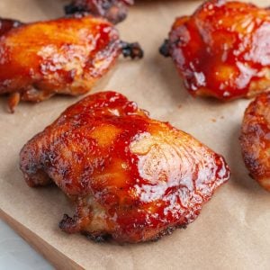 Chicken thighs covered in BBQ sauce.
