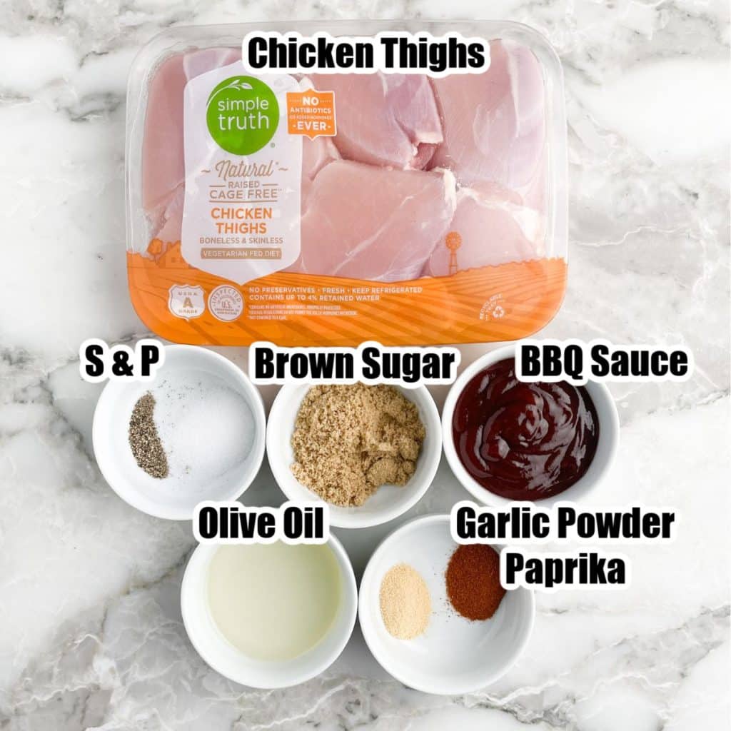 Package of chicken thighs, bowl of salt and pepper, brown sugar, bbq sauce, olive oil, and seasonings. 