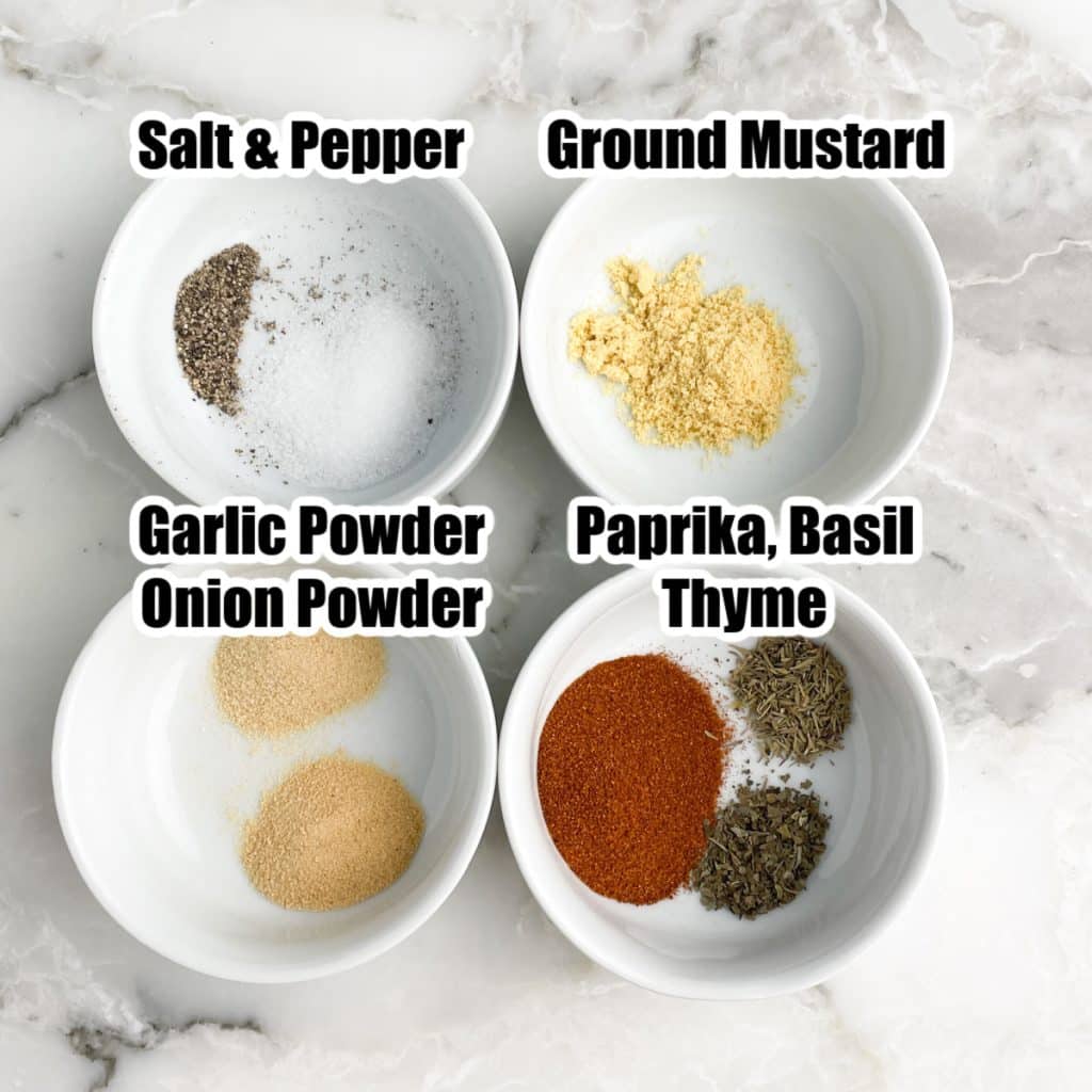 Bowl of salt, pepper, ground mustard, garlic powder, onion powder, paprika, and thyme. 