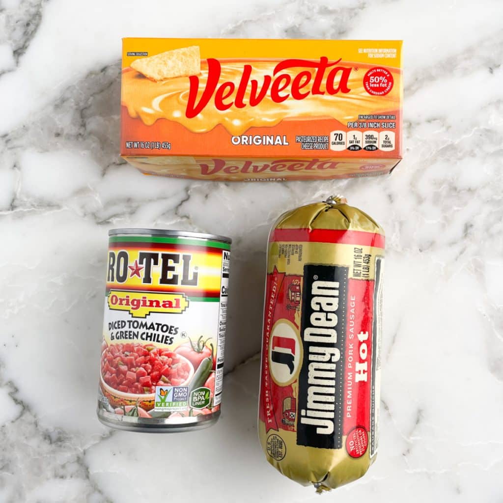 Box of Velveeta, can Rotel, roll of sausage.