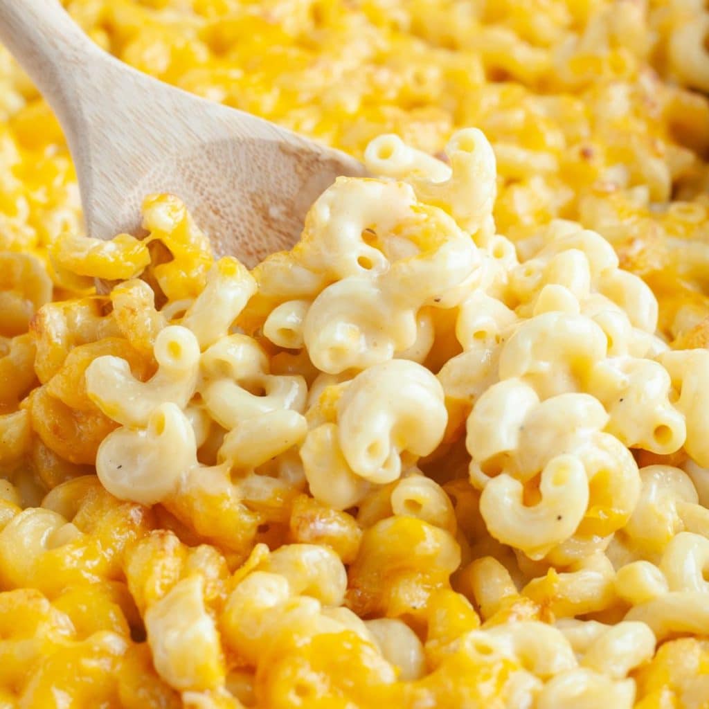 Macaroni and cheese with wooden spoon.