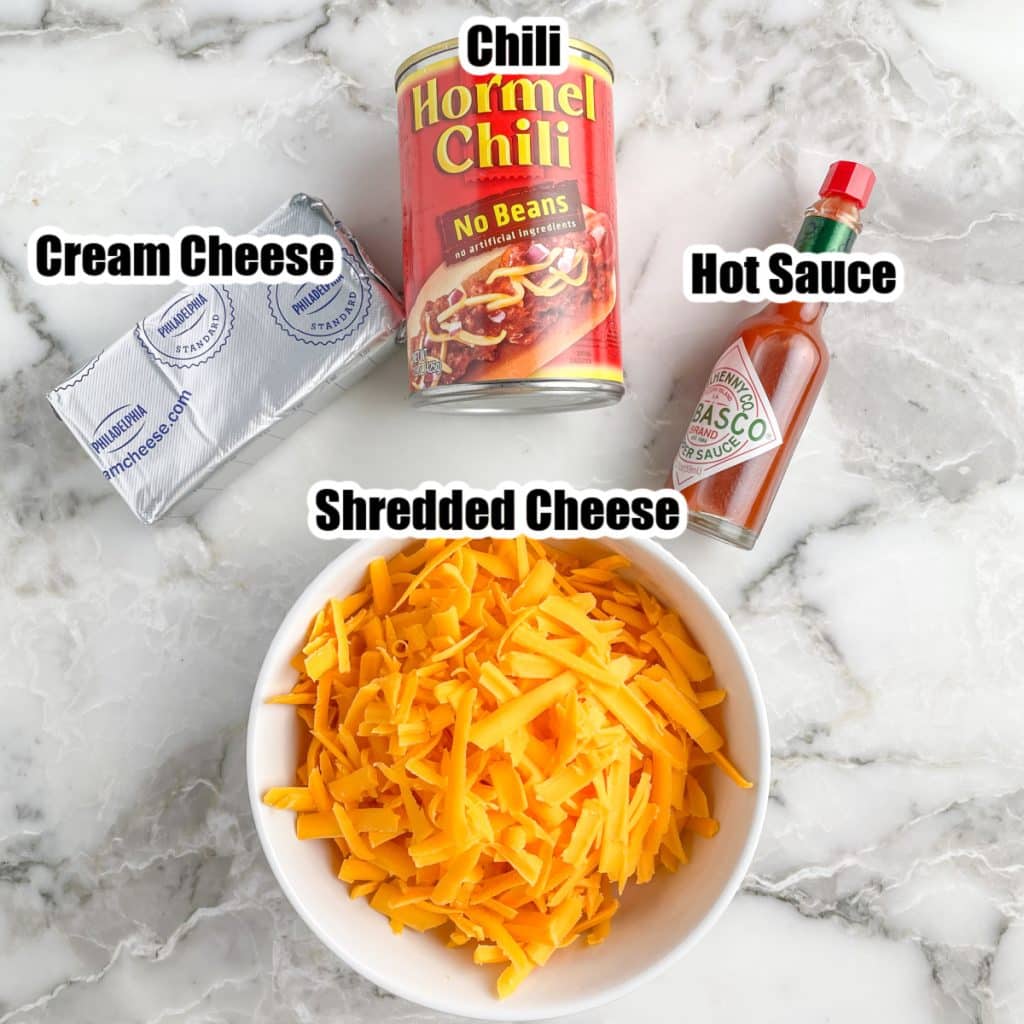 Can of chili, cream cheese, hot sauce, and bowl of shredded cheese.