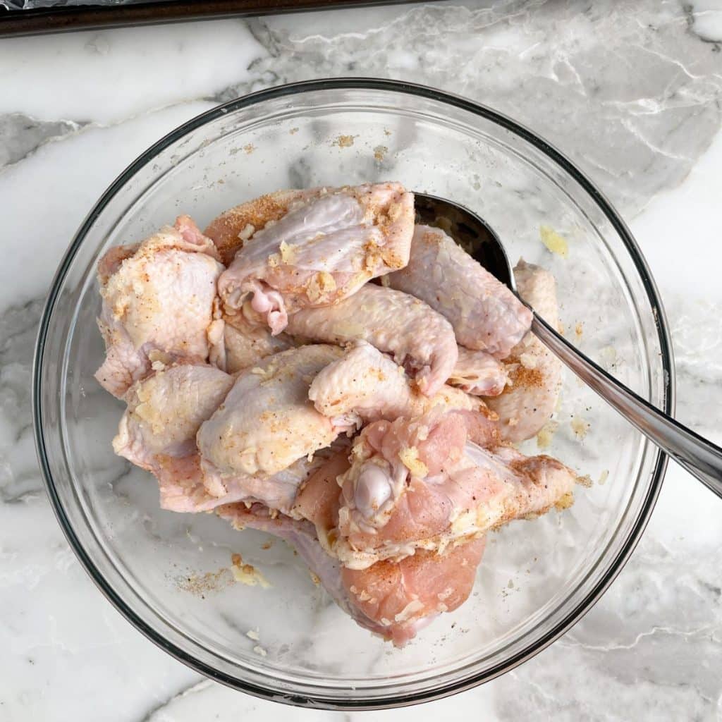 Bowl of uncooked chicken wings.